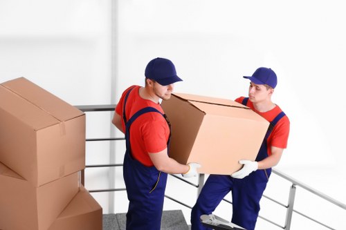 Packed moving boxes and furniture prepared for removal truck hire in Brentford