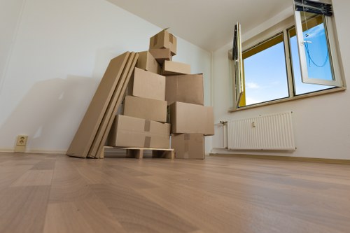 Local removals team handling furniture during house removals in Brentford